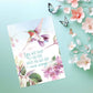 Mellow Monkey Wings of His Word religious greeting card featuring a watercolor hummingbird and floral design