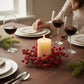 Mellow Monkey 8.5-inch iced berry candle ring with red frosted berries on a rattan base surrounding a pillar candle