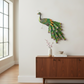 Mellow Monkey Imperial Peacock wall decor featuring embossed jewel-toned feathers in emerald, sapphire, and gold.