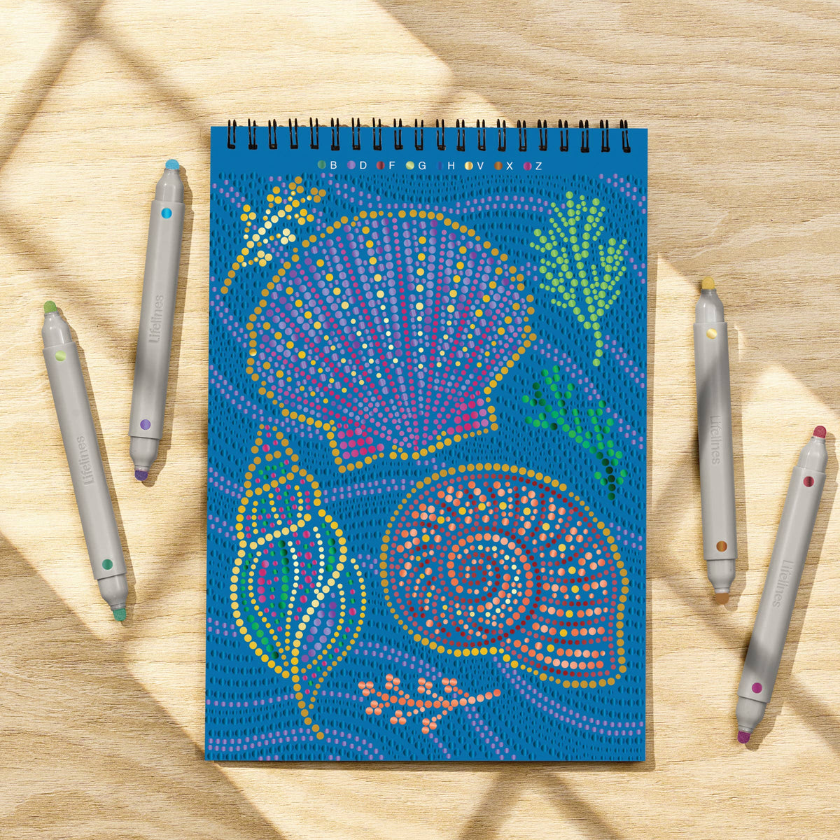 Mellow Monkey Into the Deep dot art coloring book with metallic markers featuring celestial seashell designs
