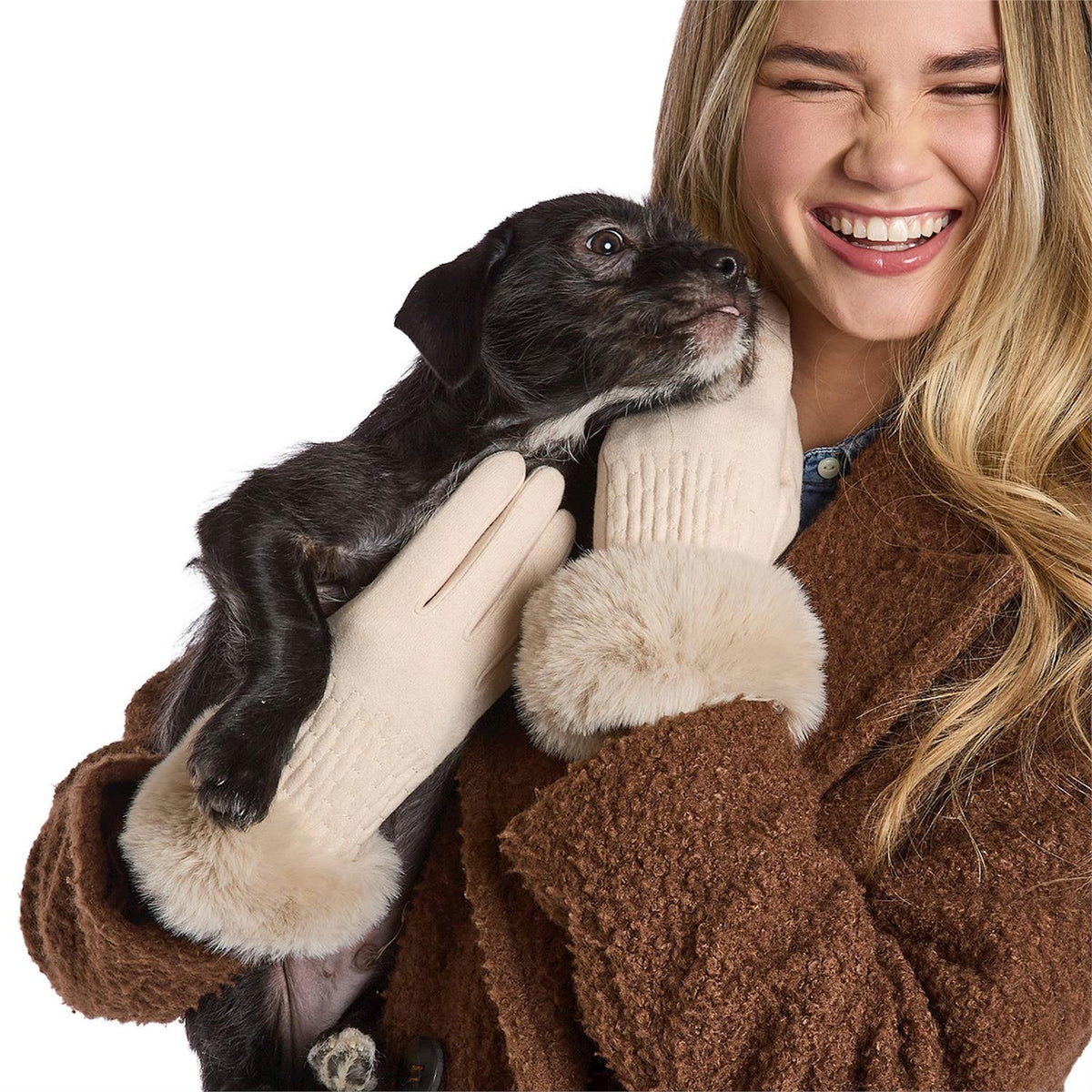 Mellow Monkey ivory knit gloves with faux fur cuffs worn by a smiling woman holding a small puppy