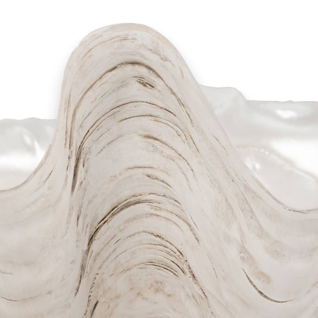 Mellow Monkey ivory resin decorative bowl with a coastal shell-inspired sculpted wave design and pearlized finish.