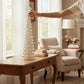 Mellow Monkey 20-inch Jewel Cone Tree with crystal-like teardrop accents on a wooden table in a bright living room.