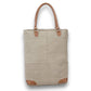 Mellow Monkey Quirky hues tote bag in beige organic jute with brown leather handles and base accents.