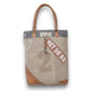 Mellow Monkey Quirky hues tote bag made from organic jute and leather with vintage-style typography and brown handles.