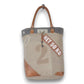 Mellow Monkey Quirky hues tote bag in beige organic jute with brown leather handles and vintage-style typography.