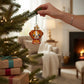 Mellow Monkey Mini Kawaii Dog blown glass holiday ornament, orange and white with big eyes, hanging on a Christmas tree.