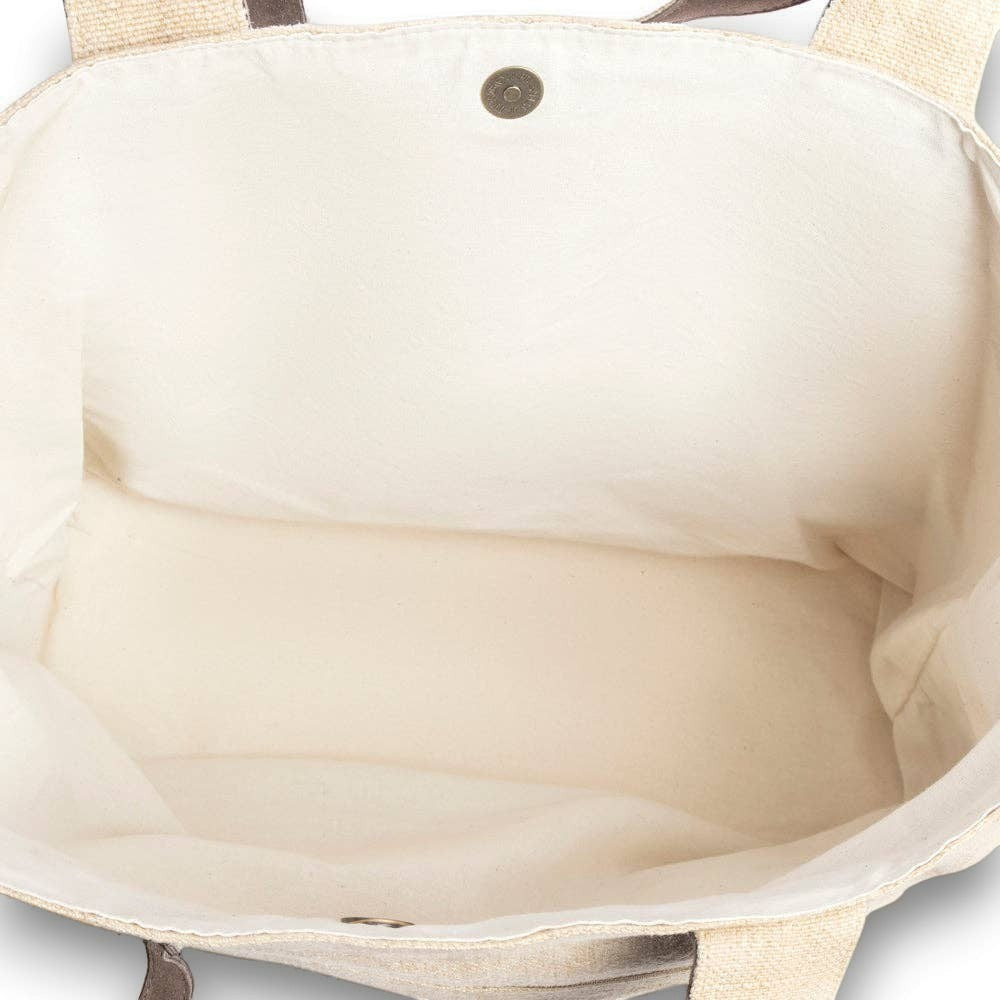 Interior view of Mellow Monkey Kendlie Mesa tote bag featuring spacious cream canvas lining and magnetic snap closure