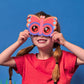 A young girl wearing Mellow Monkey Kidoki butterfly prism lenses that create kaleidoscope views over her eyes.