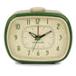 Mellow Monkey Kikkerland retro desk alarm clock in green with a glow-in-the-dark face and classic analog display.
