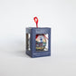 Mellow Monkey decoupage Christmas ornament featuring Kim Hovell Downtown Christmas artwork in a display box