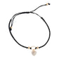 Mellow Monkey Kitt adjustable bracelet featuring a black braided band and a gold-tone heart charm with crystals.