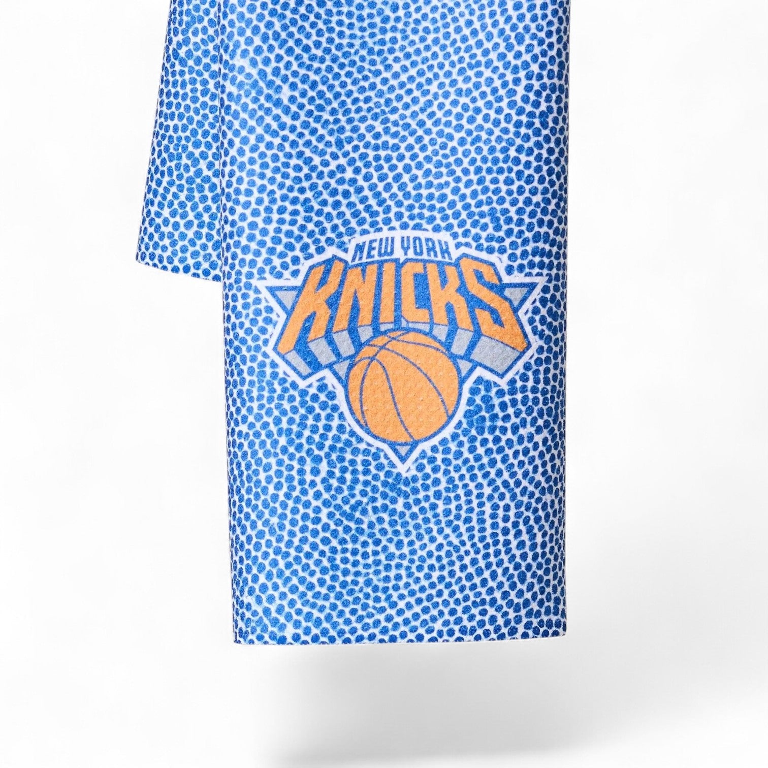 Mellow Monkey Knicks Grip tea towel in blue with a basketball texture pattern and New York Knicks team logo