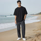 A man on a beach holding a Mellow Monkey NBA New York Knicks bottle opener keychain with a team logo design.