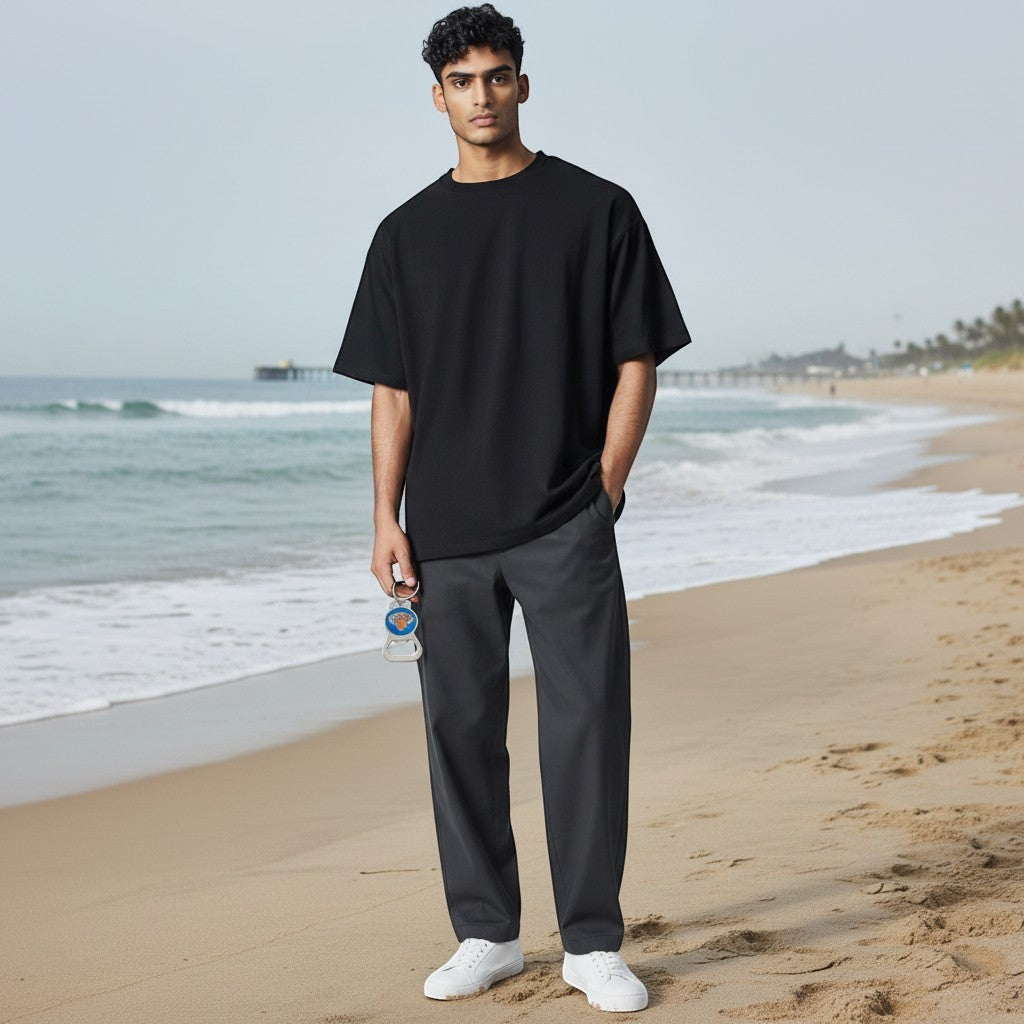 A man on a beach holding a Mellow Monkey NBA New York Knicks bottle opener keychain with a team logo design.