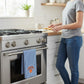Mellow Monkey Knicks classic blue and white striped tea towel hanging on a stainless steel oven handle in a kitchen.
