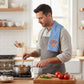 Mellow Monkey Knicks tea towel with blue and white stripes draped over a man cooking in a bright kitchen