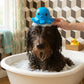 Mellow Monkey Kobe Octopus Grooming Brush in blue being used to lather a wet dog in a bathtub.