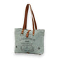 Mellow Monkey La Couspaude canvas tote bag in sage green with brown leather handles and vintage-style graphic print.