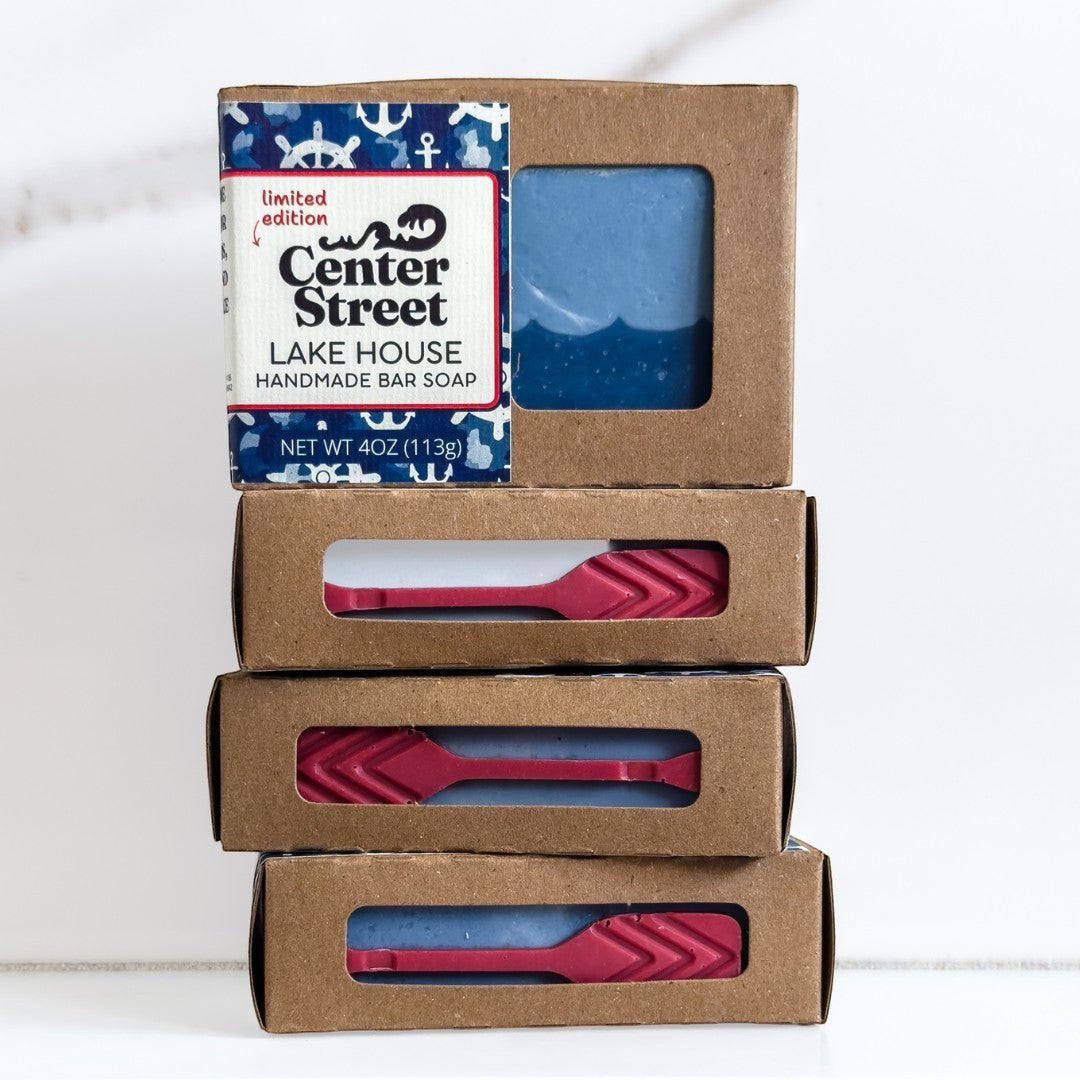 Mellow Monkey Lake House handmade bar soap, blue with white wave design, in kraft box with nautical print.