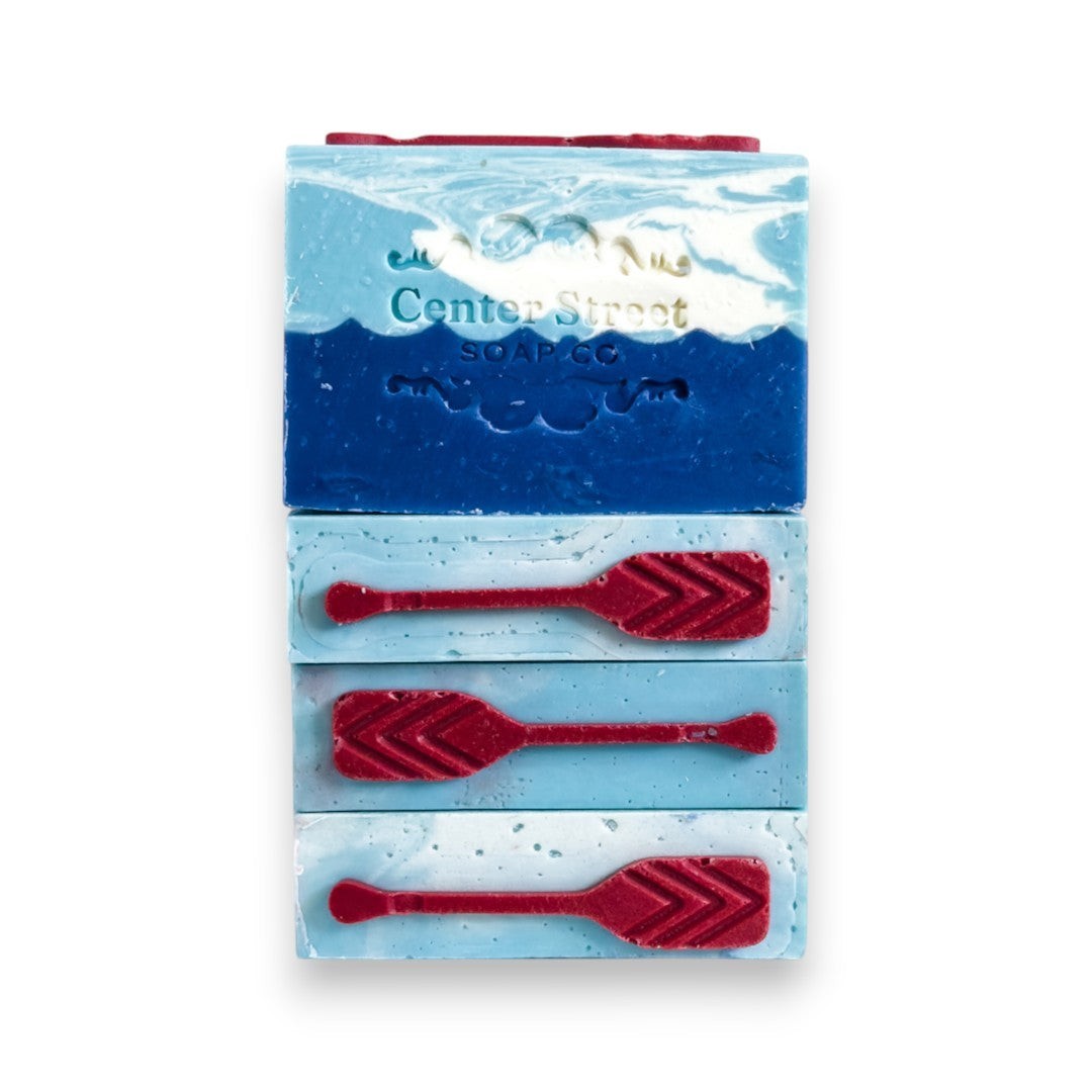 Mellow Monkey Lake House Summer handmade soap bar with blue ocean waves and red oars. 4-oz bar.