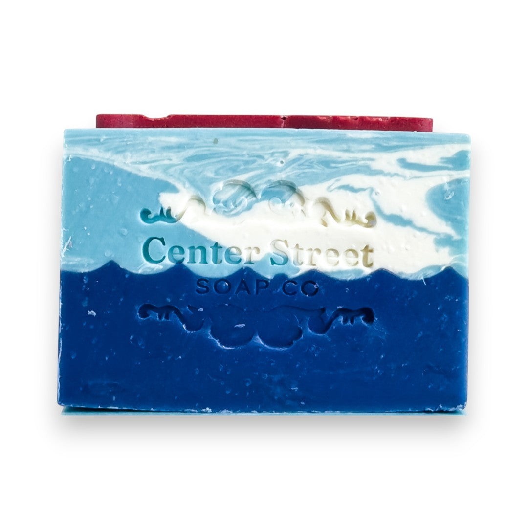 Mellow Monkey Lake House Summer handmade soap bar, 4-oz, with blue and white swirls resembling water and sky.