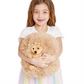 A young girl smiling while holding a large, round, tan Mellow Monkey Snuggle Puff hedgehog plush toy.