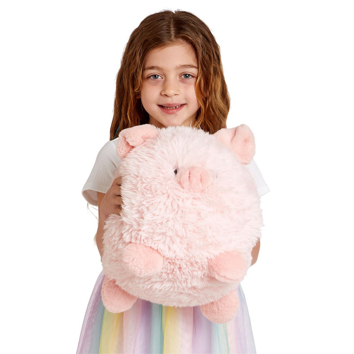 Young girl holding a large, round, pink Mellow Monkey Snuggle Puff piggy plush toy with soft polyester fur.