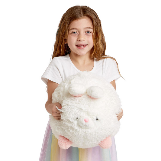 Young girl holding a Mellow Monkey Snuggle Puff large white plush bunny with soft polyester fur.