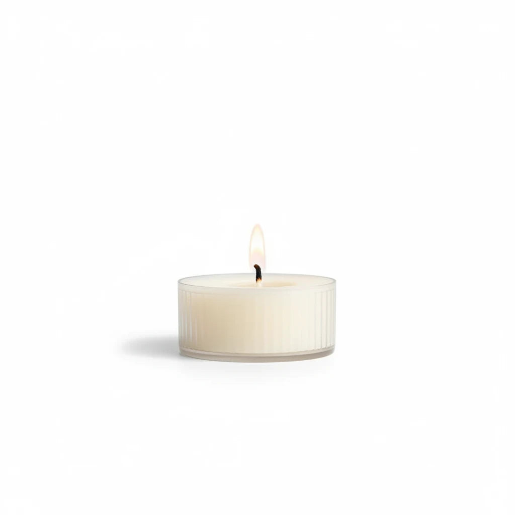 Mellow Monkey Lavender Green Tea mini candle in a clear ribbed glass jar with a lit wick on a white background