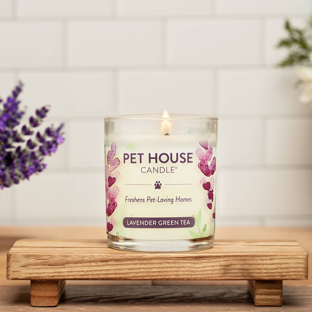 Mellow Monkey Pet House Candle in Lavender Green Tea scent, a 9-oz odor-neutralizing candle on a wooden stand.