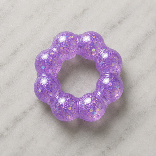 Mellow Monkey Lavender Sparkle Feelzies sensory bracelet with glittery purple squishy texture on marble surface.