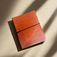 Mellow Monkey hand-stitched tan leather journal with unlined pages and elastic closure. Geometric debossed corners.