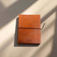 Mellow Monkey tan leather journal with debossed pattern, elastic closure, and unlined handmade paper. 8x6 inches.