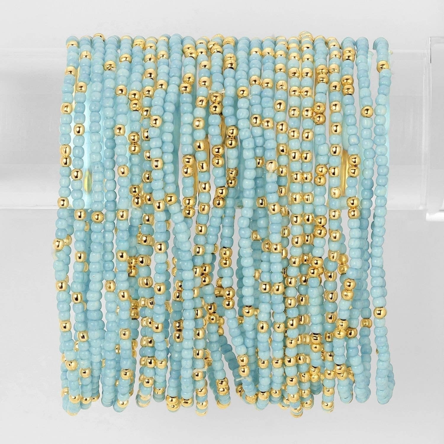 Mellow Monkey light blue seed bead stretch bracelets with 18K gold plated brass accents for a layered stackable look.