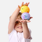 Mellow Monkey light up hedgehog sensory toys in yellow and purple held by a smiling child