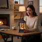 Mellow Monkey lighted water lantern snow globe with a cardinal inside, sitting on a wooden table in a cozy living room