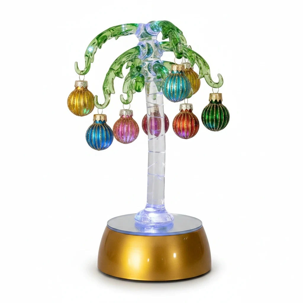 Mellow Monkey 9-inch lighted green glass palm tree decorated with colorful mini holiday ornaments on a gold base