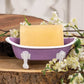 Mellow Monkey Lilac Iron Bathtub Soap Dish with white feet and rim, holding a bar of soap.