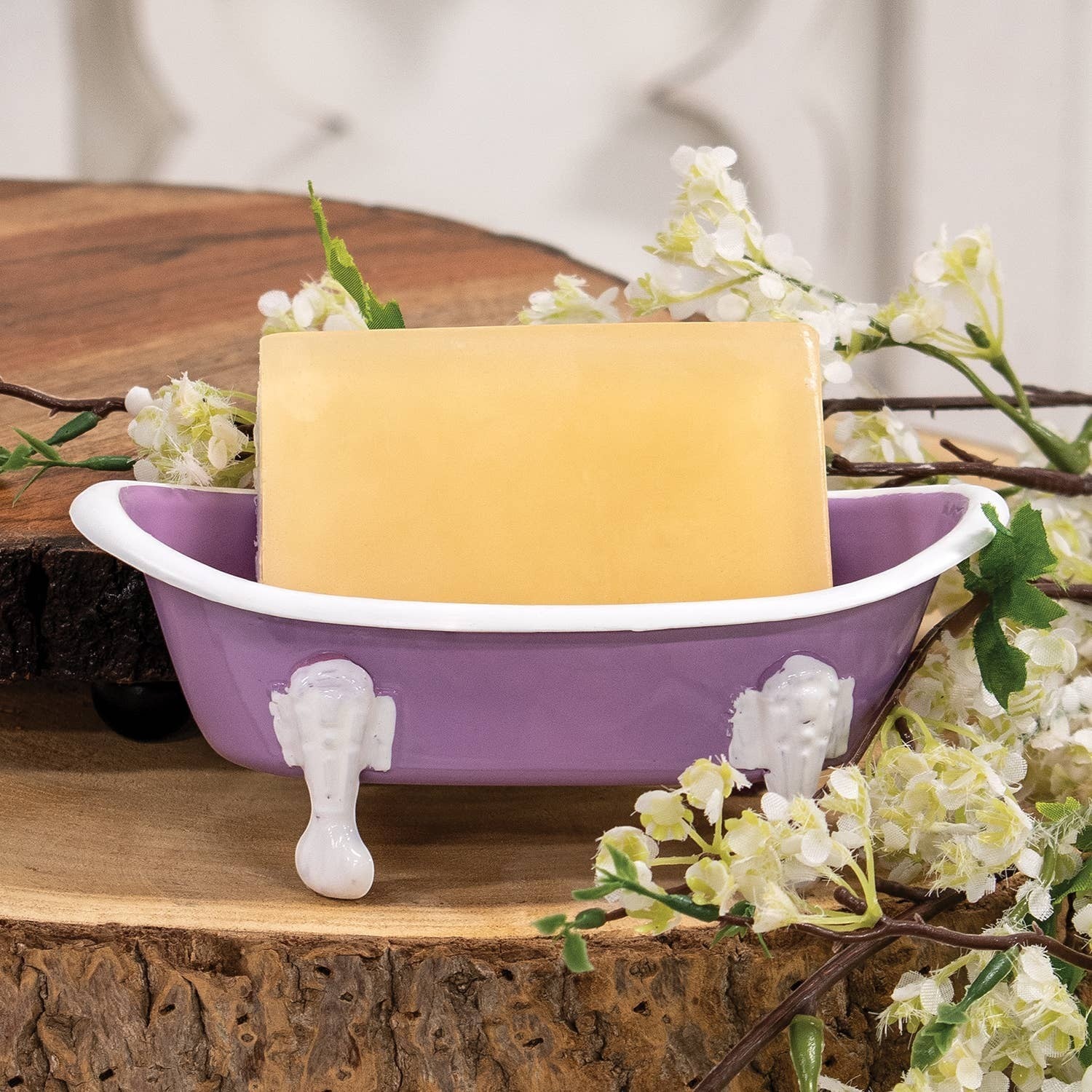 Mellow Monkey Lilac Iron Bathtub Soap Dish with white feet and rim, holding a bar of soap.