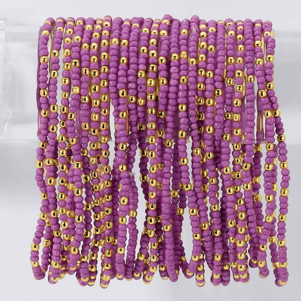 Mellow Monkey lilac seed bead stretch bracelets with interspersed 18K gold plated brass beads for a layered look.