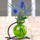 Mellow Monkey Casablanca lime green recycled glass mini vase suspended in a black metal stand with blue thistle