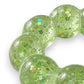 Mellow Monkey Lime Pop Feelzies sensory bracelet with green glitter and flower confetti in a squishy ring design.