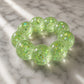 Mellow Monkey Lime Pop Feelzies sensory bracelet in translucent green with glittery flower and star confetti