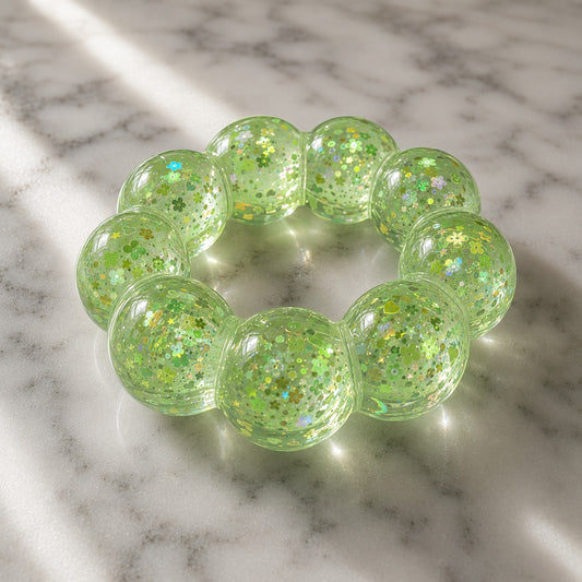 Mellow Monkey Lime Pop Feelzies sensory bracelet in translucent green with glittery flower and star confetti