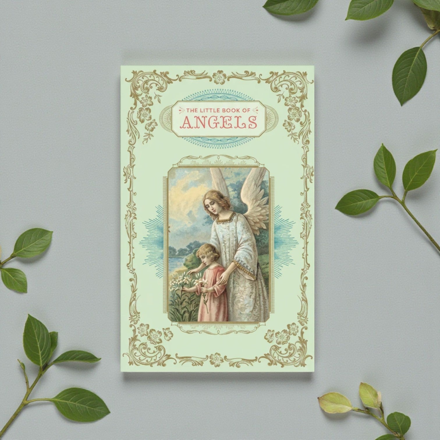 Mellow Monkey The Little Book of Angels, a padded hardcover book with gilded edges and ribbon marker, featuring an angel and child illustration.