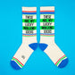 Mellow Monkey cream gym crew socks with blue heel and toe, green and red stripes, and a small mahjong tile icon.
