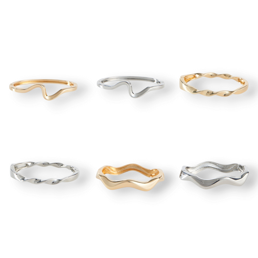 Mellow Monkey Lumi hinged cuff bracelets in polished gold and silver with smooth wave and twisted silhouettes.