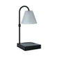 Mellow Monkey Lumiere candle warmer lamp with a sleek black metal frame and a fluted clear glass shade.