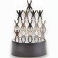 Mellow Monkey magnetic desktop sculpture featuring stainless steel humanoid figures stacked on a circular base.